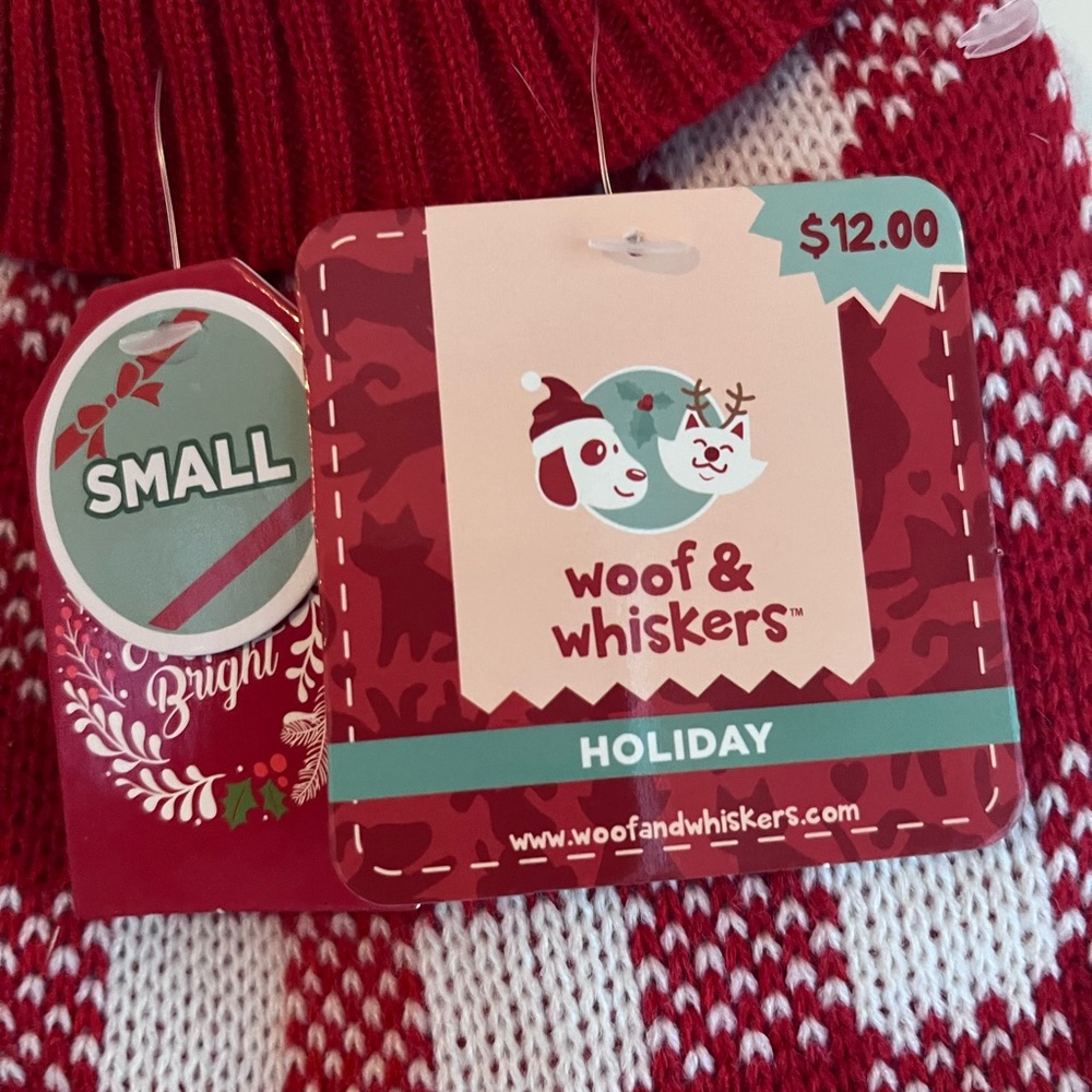 New red and white dog sweater size small. Does not fit my pug (20 lbs).